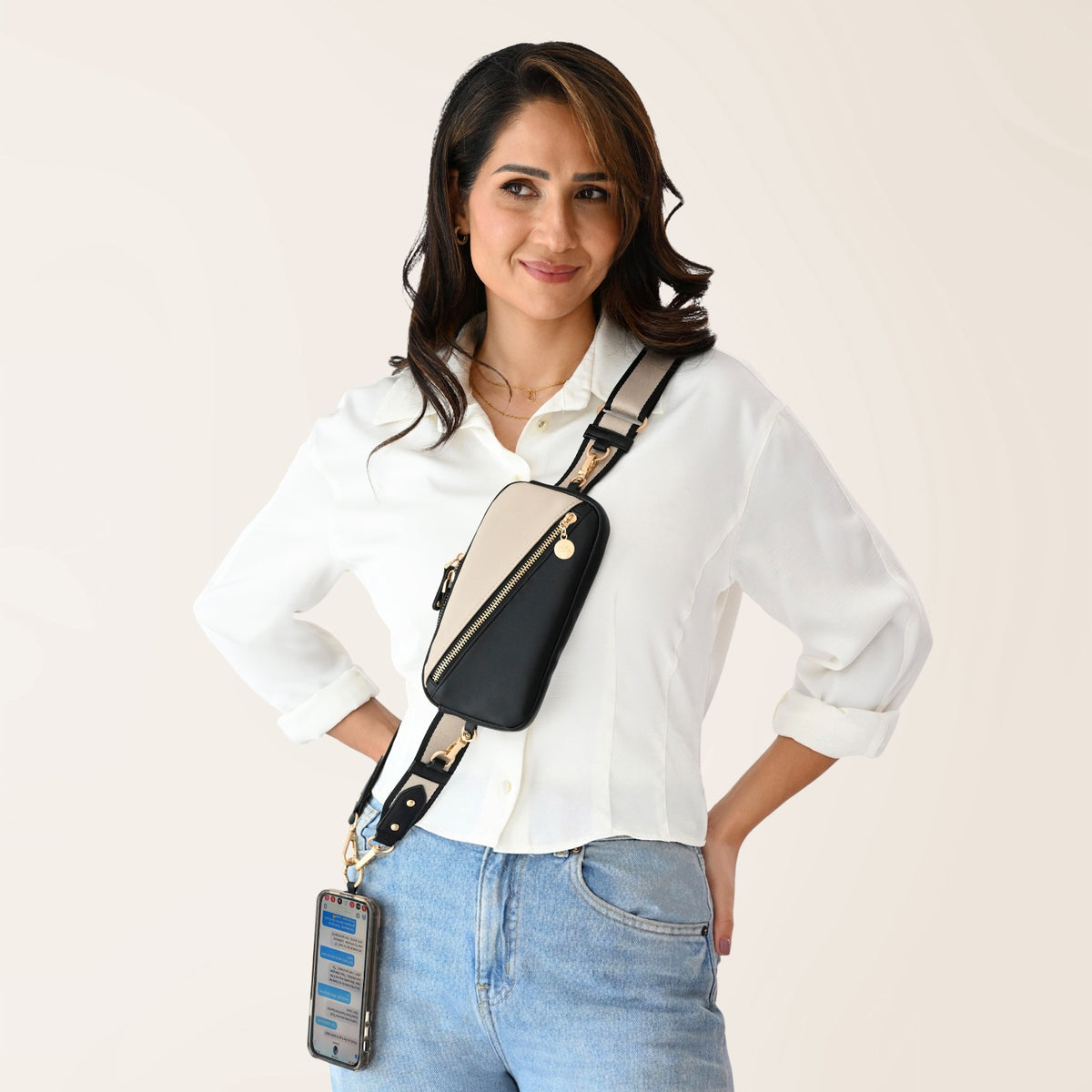 Nova Zip & Clip RFID Strap in Black and Cream worn crossbody, crossbody phone bag, RFID crossbody bag, phone crossbody strap, Save The Girls phone strap